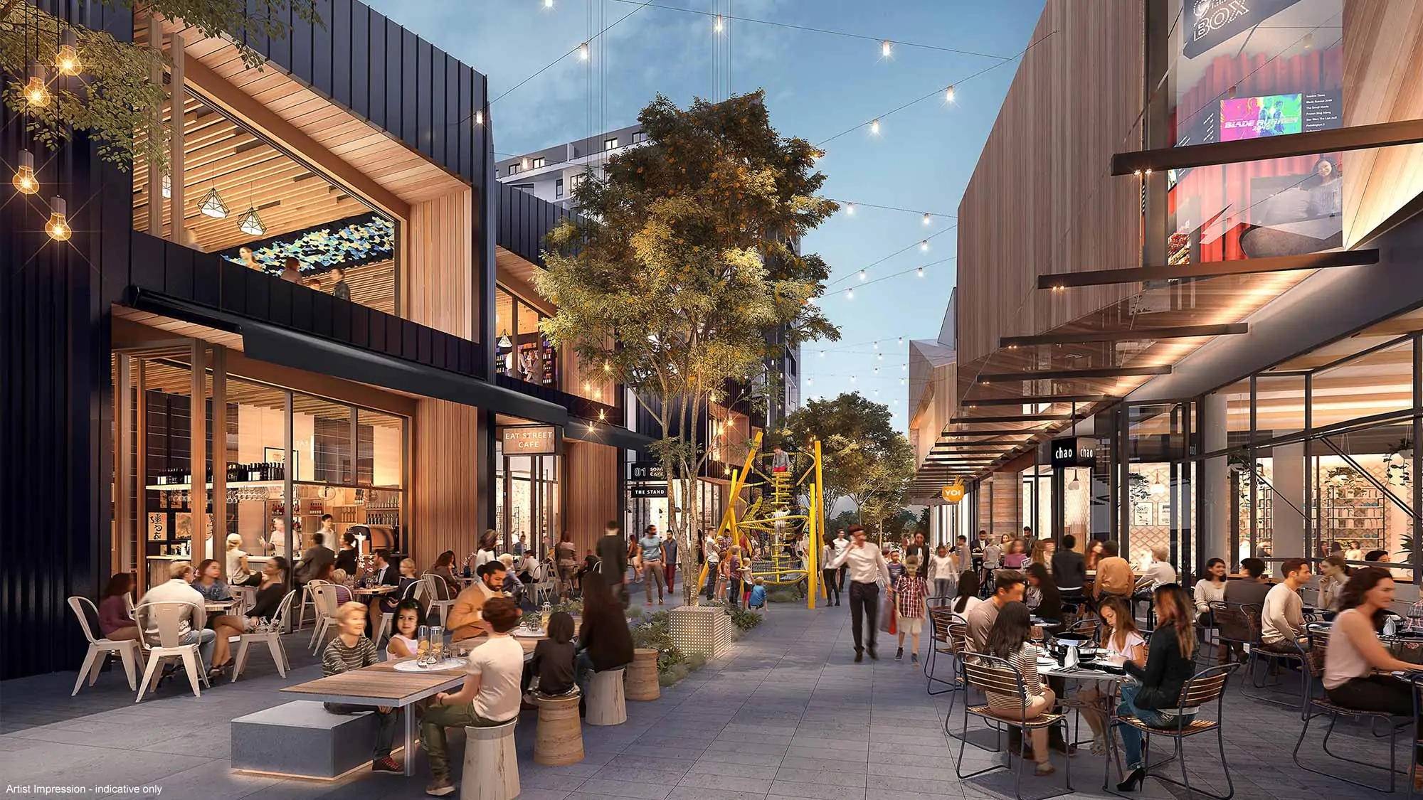 A lively outdoor urban plaza with people dining at café tables, string lights overhead, trees, modern buildings, and colorful public art in the center, creating a vibrant, social atmosphere.