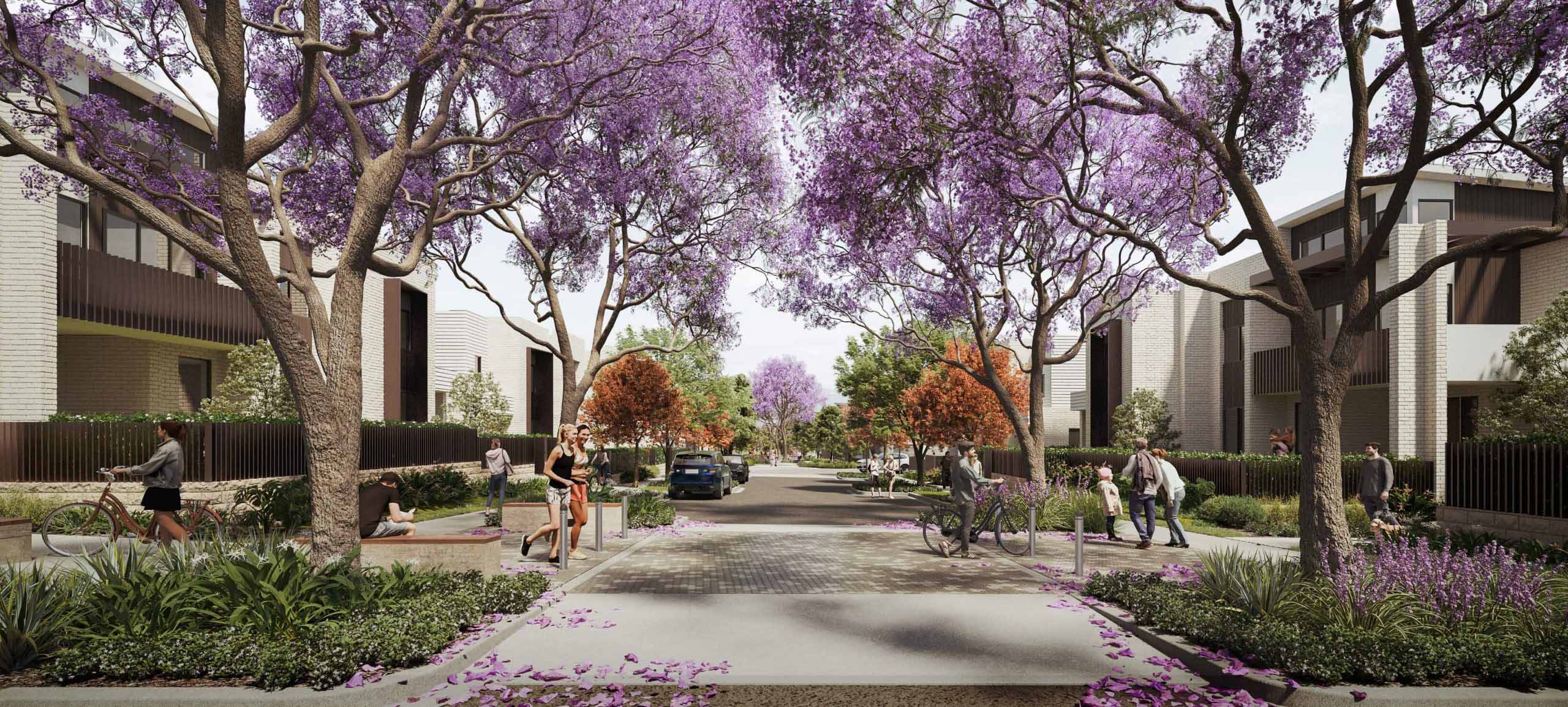A tree-lined street with blooming purple jacarandas, people walking, cycling, and sitting on benches. Modern buildings line both sides, and cars are parked along the curb. Flower petals are scattered on the pavement.