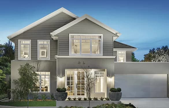 Modern two-story gray house with large windows, white trim, a double garage, and outdoor lighting. The front yard features decorative plants, small trees, and tidy landscaping at dusk.