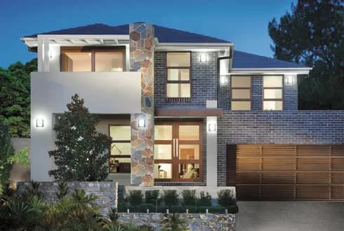 A modern two-story house with large windows, stone and brick exterior, a wooden garage door, balcony, and landscaped front yard, illuminated by outdoor lights at dusk.