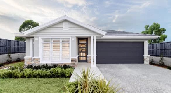 Modern single-story house with light gray exterior, large front windows with white shutters, a dark double garage door, and a well-manicured front yard with green plants and shrubs, under a partly cloudy sky.