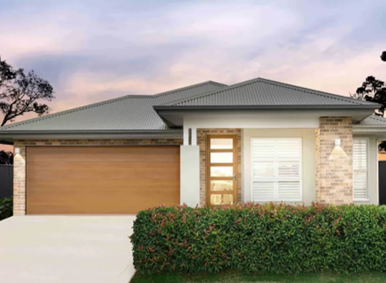 Modern single-story house with a gray metal roof, brick and white exterior, large wooden garage door, glass-paneled front door, white shutters, and neatly trimmed hedges in front.