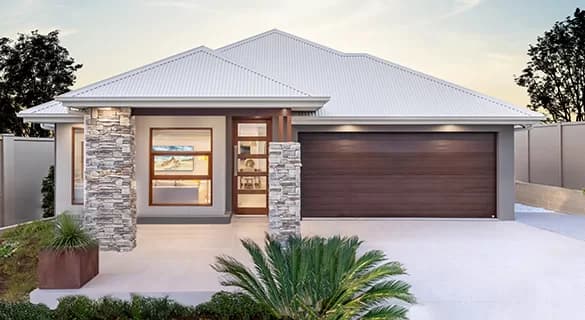 Modern single-story house with a white roof, light gray exterior, stone pillar accents, large windows, double wooden garage door, landscaped front yard, and a paved driveway.